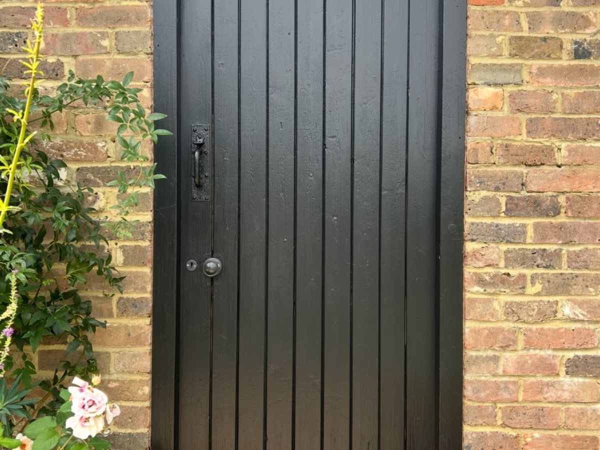 After, Garage door refinished from faded grey to a rich black