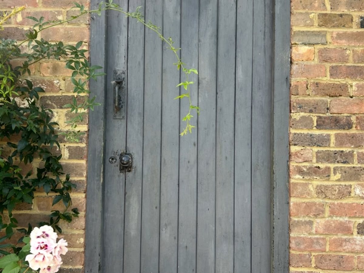 Before, Garage door refinished from faded grey to a rich black